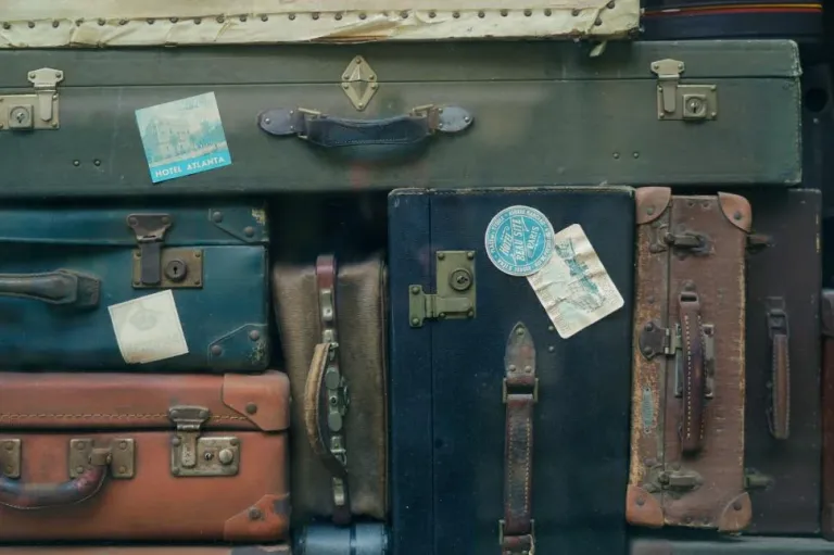 vintage-suitcases-with-travel-stickers Vacation Audit: How Tourism Pros Really Travel